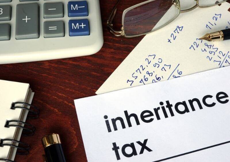 Inheritance tax paperwork next to calculator